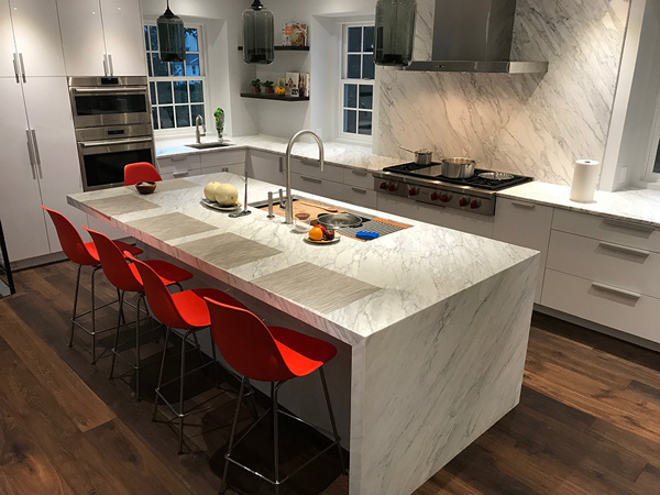 A kitchen countertops installation with white marble island countertop.